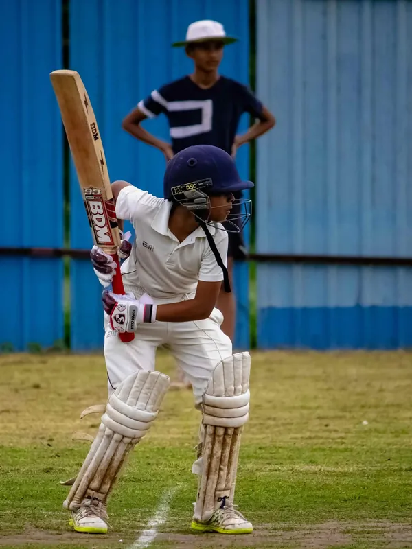 A young batsman playing a shot in the nets at Kreeda Kshetra